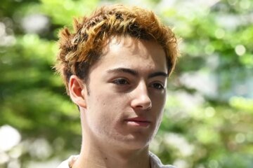 French teen charged in Singapore over a vending machine straw-licking video